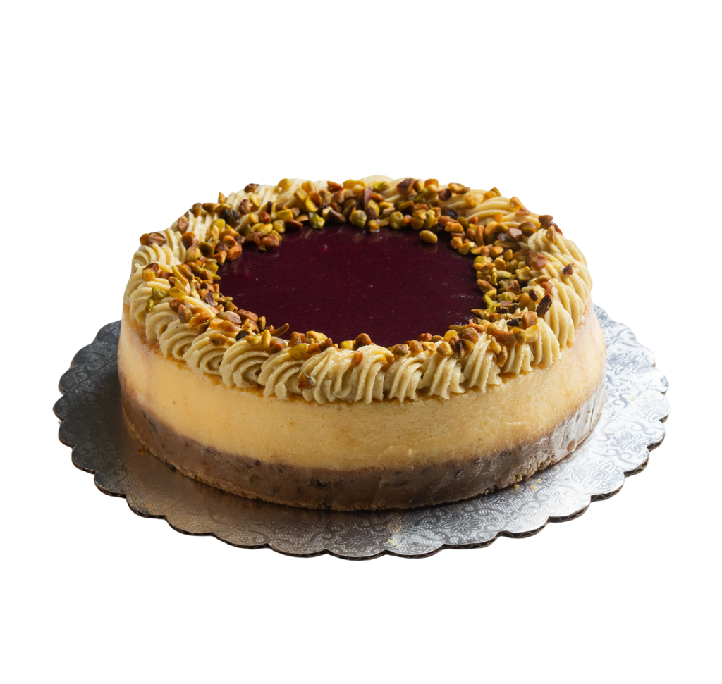 Cheesecake de chocolate blanco con crust y ganache con pistacho y frutos rojos 7"